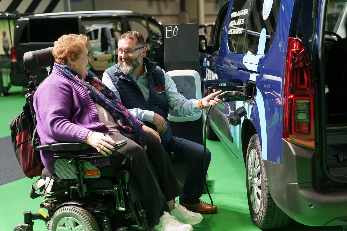 An electric Wheelchair Accessible Vehicle being plugged in to charge