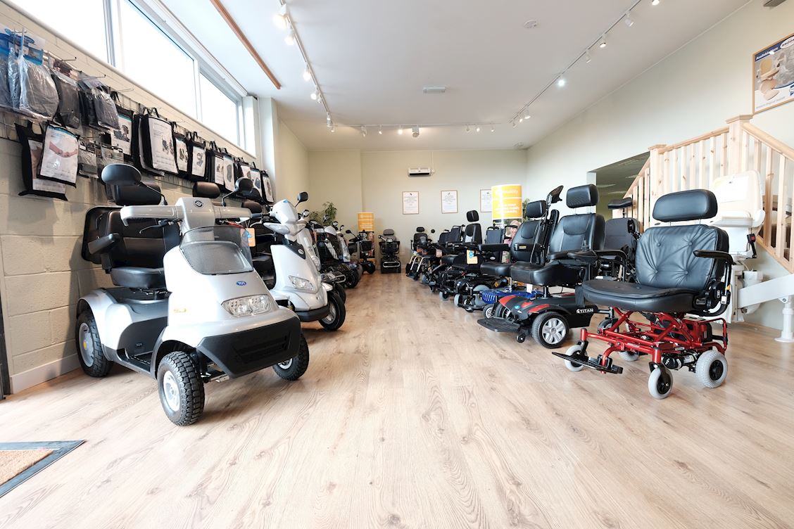 Scooters and powered wheelchairs inside a dealer showroom