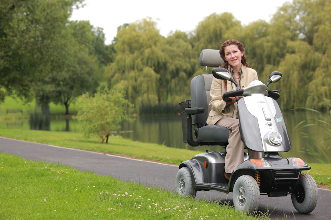 A woman riding a large mobility scooter