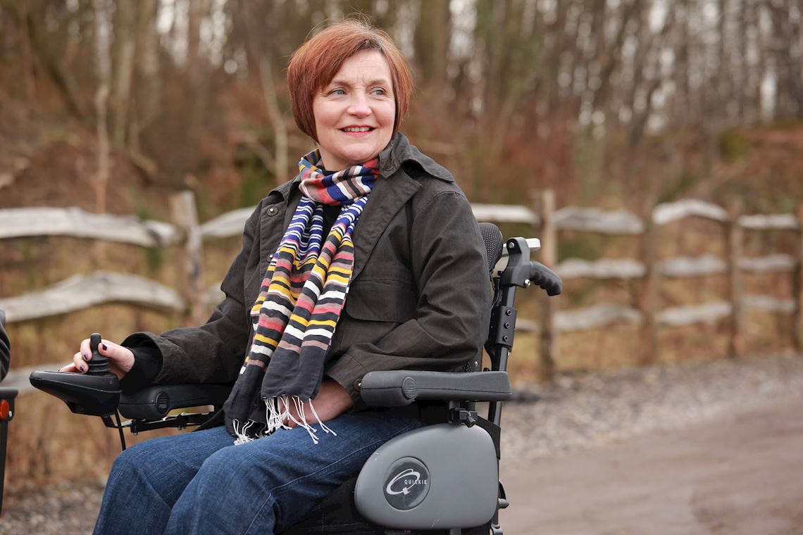 A woman in a powered wheelchair