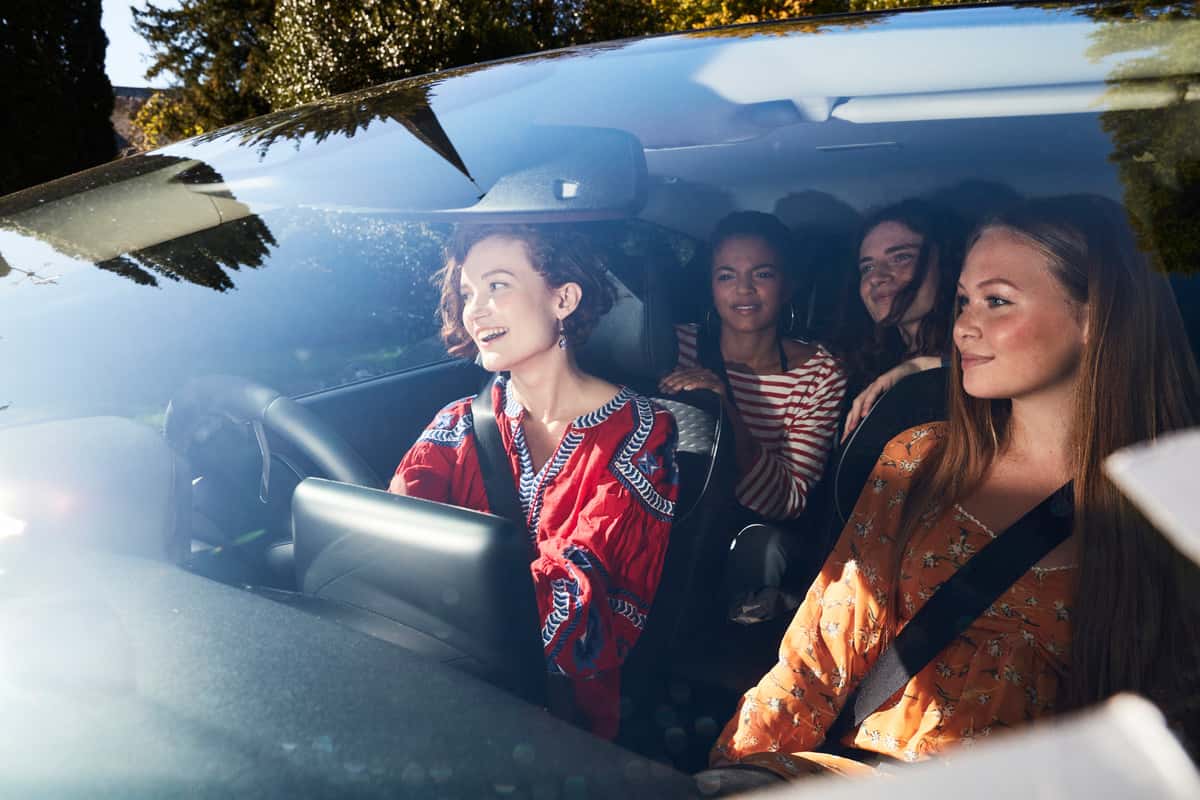 A group of women sitting inside a car