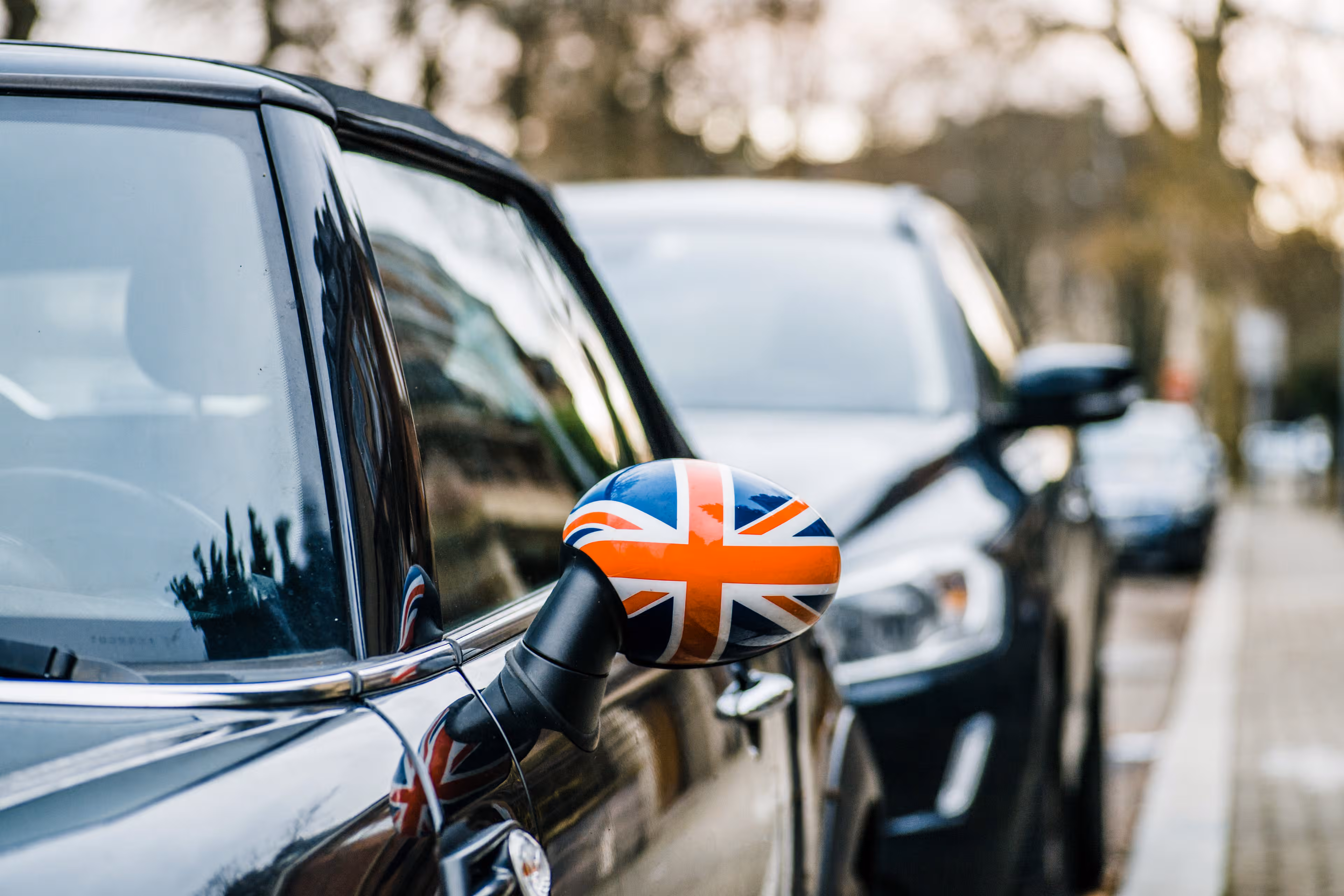 Union Jack flag on the mirror of a parked Mini Cooper car
