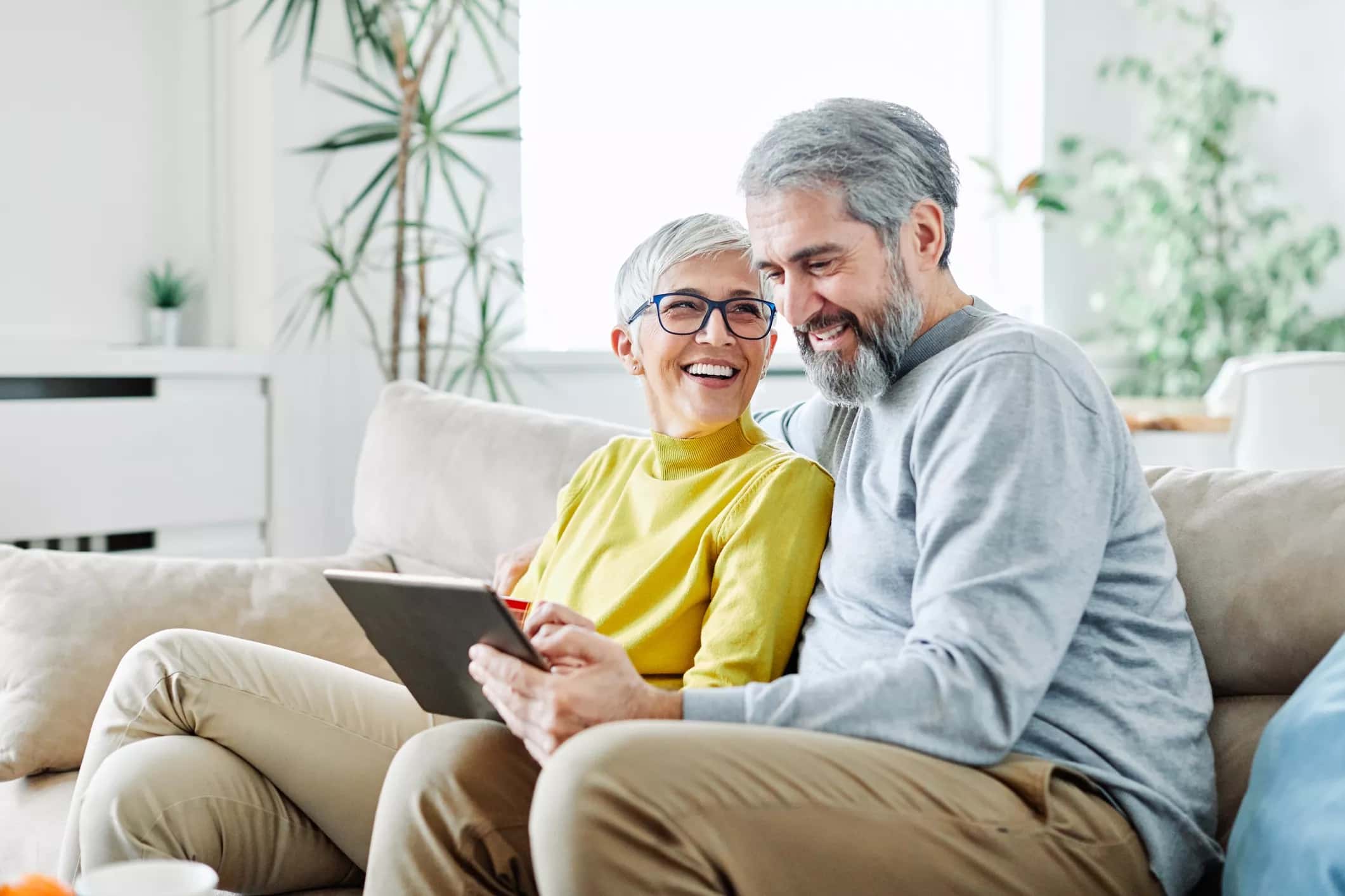 couple smiling at a tablet