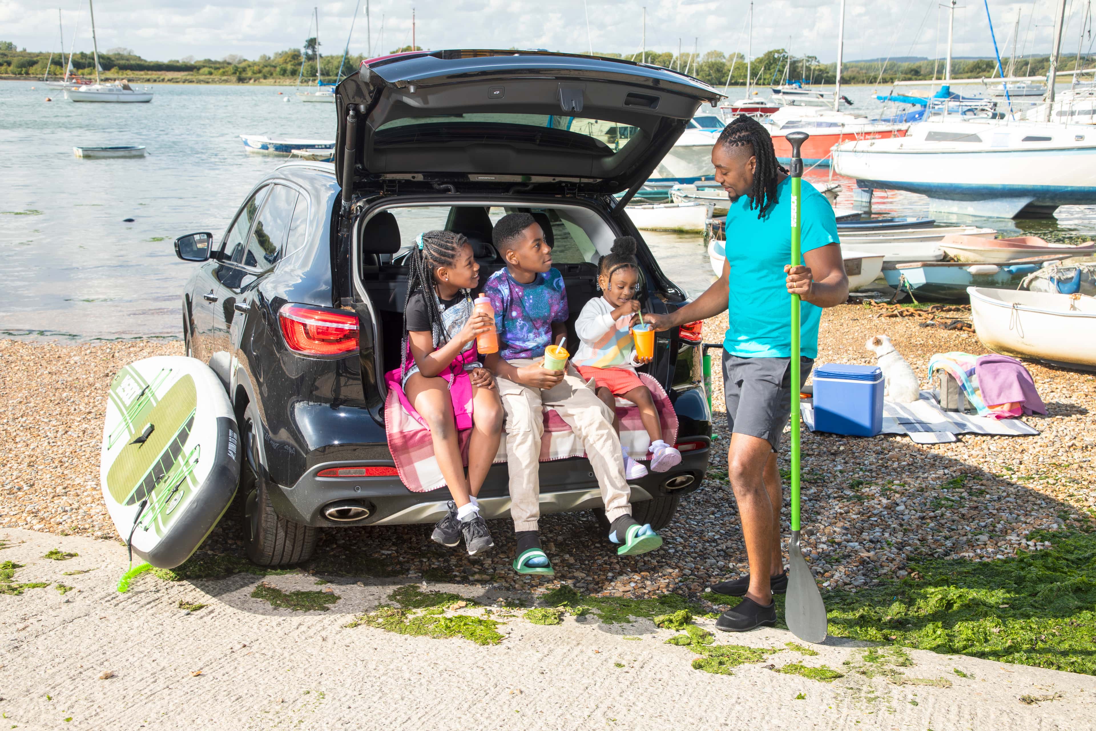 Children in boot by the sea