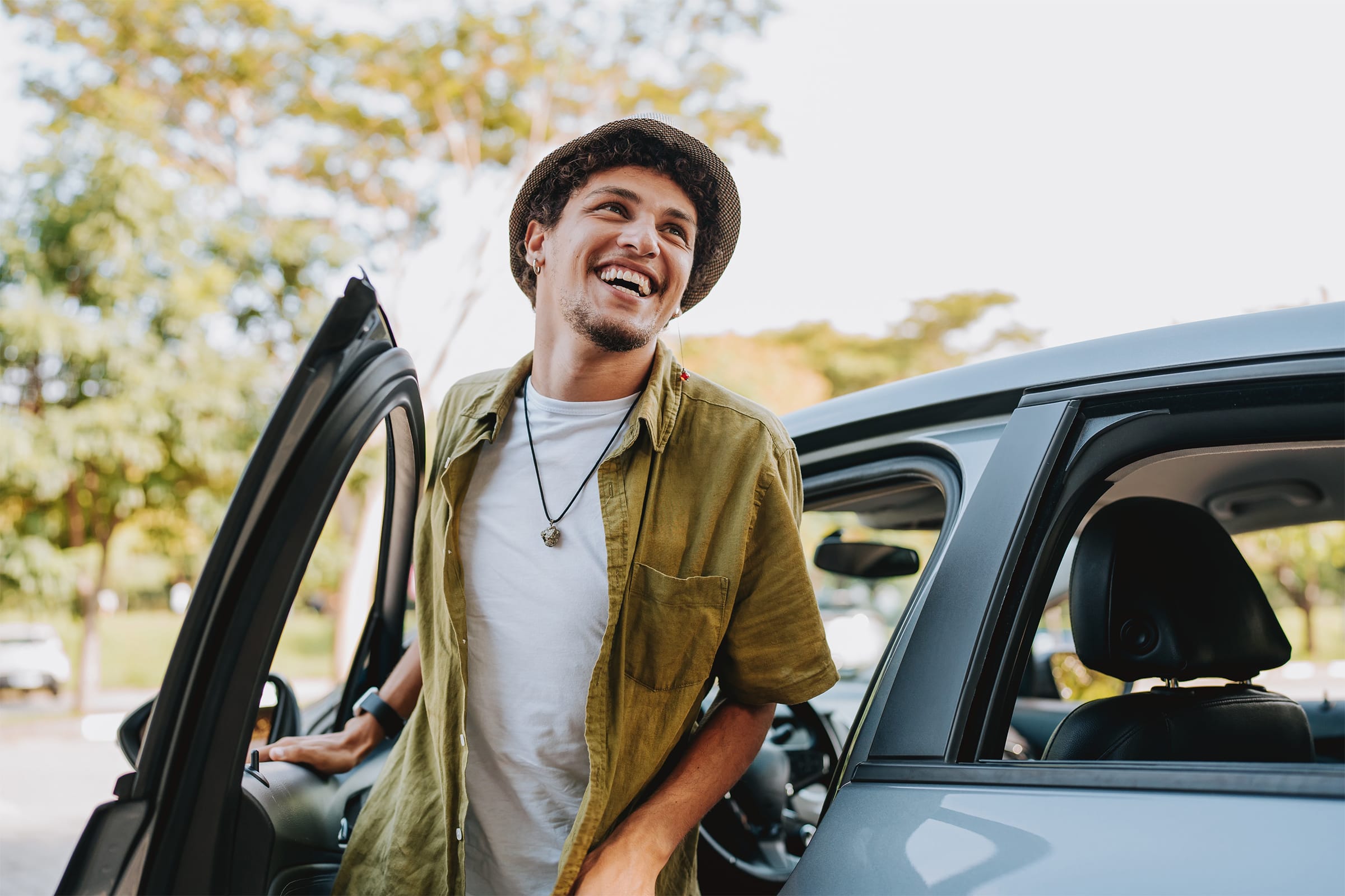 Man getting out of car smiling