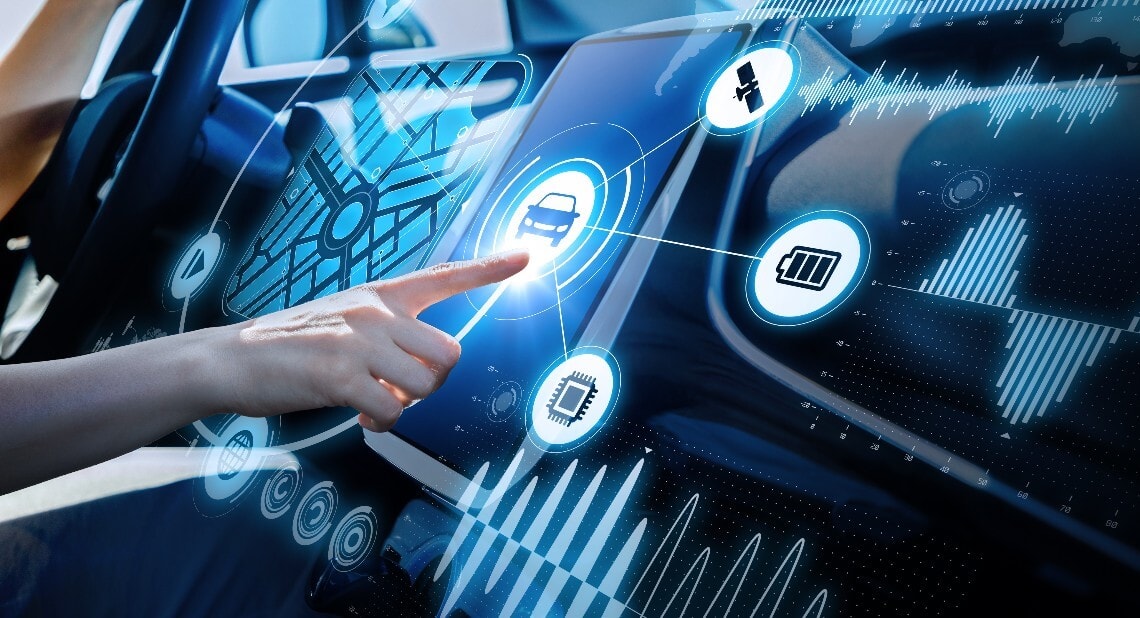 Hand pointing towards a touchscreen in a car with certain features highlighted